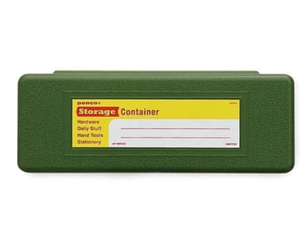 A hard, green pencil case with a label on the front.