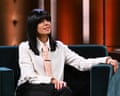 Claudia Winkleman on her chatshow sofa wearing a white blouse and peach tie