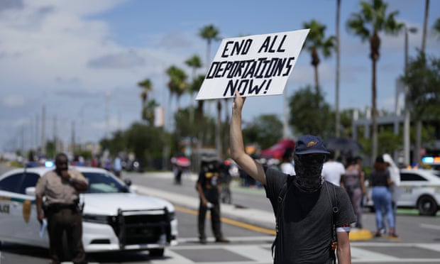A man holds up a sign as members of Miami's Haitian community and other supporters protest against the deportation of Haitians arriving at the US border, in Miami last month.