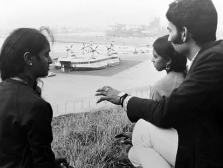a men and two women looking out to water