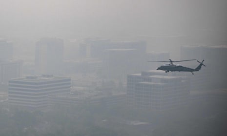 In this aerial view, Marine One with US President Joe Biden flies over a hazy Chicago, Illinois, on June 28, 2023.