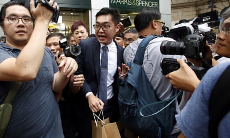 Andy Chan is surrounded by photographers in Hong Kong
