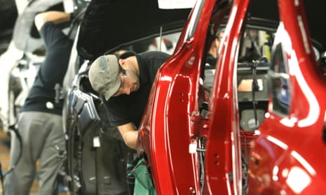 Employees work on the production line at Nissan's Sunderland factory