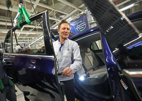Thomas Schäfer, CEO of Volkswagen Passenger Cars, next to a vehicle as its door gets dismantled for recycling at Volkswagen's first Circular Economy facility, at the company's EV factory in Zwickau, on 28 October.
