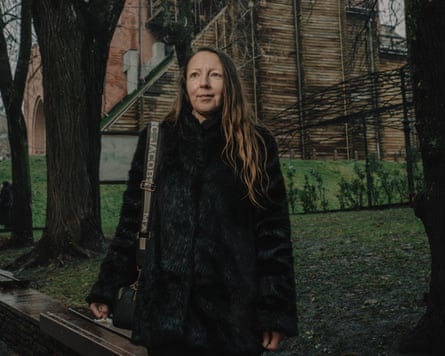 Forty-year-old Ukrainian woman standing, part of Golden Gate monument visible behind her.