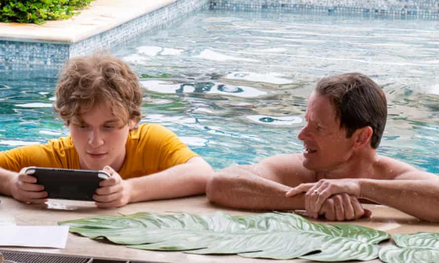 teen boy with phone and dad in pool