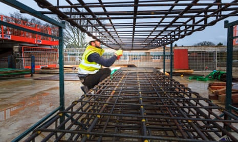 Construction worker forming concrete reinforcing bars