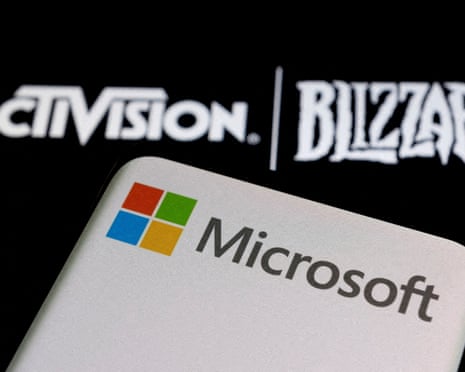 microsoft logo on smartphone against background saying activison blizzard