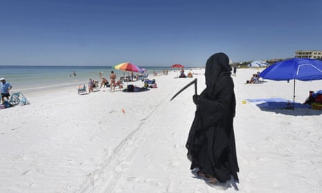 Daniel Uhlfelder, a Florida attorney, dressed as the Grim Reaper at the newly opened beach near Destin, Florida, on 1 May. 