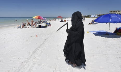 Florida attorney Daniel Uhlfelder, dressed as the Grim Reaper, walks the newly-opened beach near Destin, Florida, on 1 May 2020. 