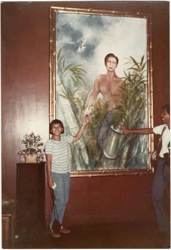 Abad’s mother posing next to a portrait of Ferdinand Marcos after storming the palace in 1986.