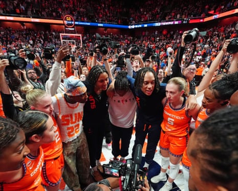 Members of the Connecticut Sun team stand in a circle after a game.