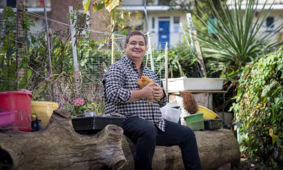 Ivan Markov, with chicken Marcey, outside his home in  south-east  London.