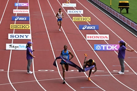 Amanal Petros falls as he crosses the finish line behind Alphonce Simbu