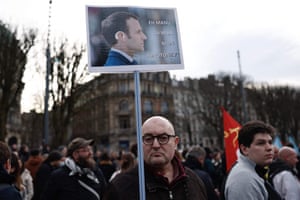 A protester holds a placard reading ‘hey Manu, do you want my hearing device?’ in Lille