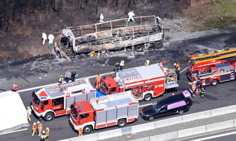 Emergency vehicles at the scene of bus blaze in Bavaria, which killed 18.