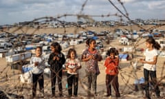 Children near a camp housing displaced Palestinians in Rafah