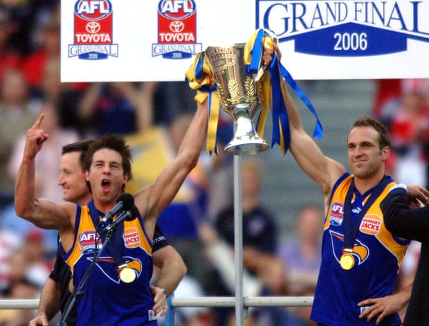 West Coast Eagles' Ben Cousin and captain Chris Judd hold the 2006 premiership trophy above their heads.