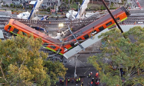 Two subway carriages hang from the collapsed overpass in Mexico City. At least 24 people have died in the disaster.