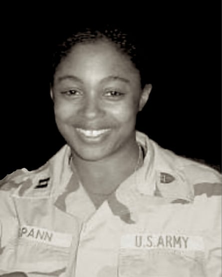 woman in military fatigues smiles