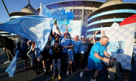 Manchester City fans celebrate outside the Etihad Stadium