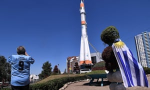 A Uruguay fan takes a photo of the Russian Soyuz booster rocket displayed at the entrance of the Samara Space Museum in Samara.