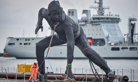 The Messenger sculpture arrives in Plymouth by barge to be installed outside the city’s Theatre Royal