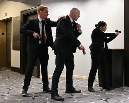Agents draw their guns at the Washington Hilton on Saturday night.