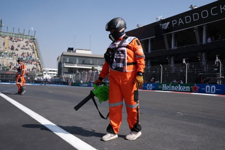 Members of the intervention fire rescue truck team use blowers to clear debris from the track after a crash during the GTM race at the Mexico City Grand Prix.