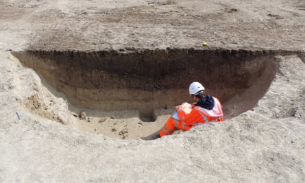 An archaeologist recording a large Mesolithic pit at Linmere