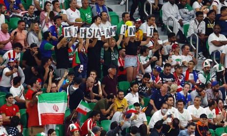 Spectators hold up the name of Mahsa Amini at the Iran v USA match