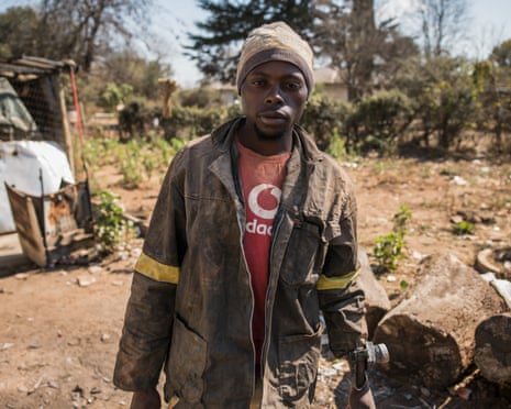 A zama zama prepares to go underground in Durban Deep, an abandoned Victorian-era gold mine.