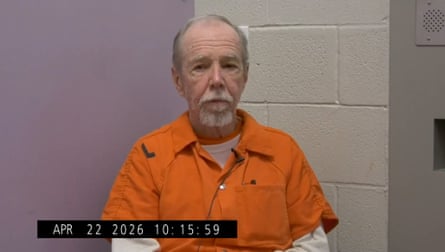 An older man in a orange jumpsuit