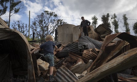 Bushfire survivor Ian Livingston and his son Sydney, 6, among the ruins of their family home, lost to the New Year’s Day bushfires in Cobargo.