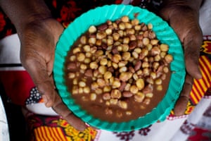 Mary Nasia, 63, is a widow who cooks and sells beans to make a living on the side of the road in Kibera.