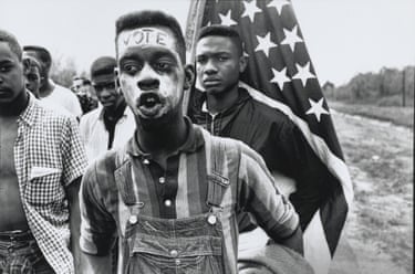 a man walking with “vote” on his forehead