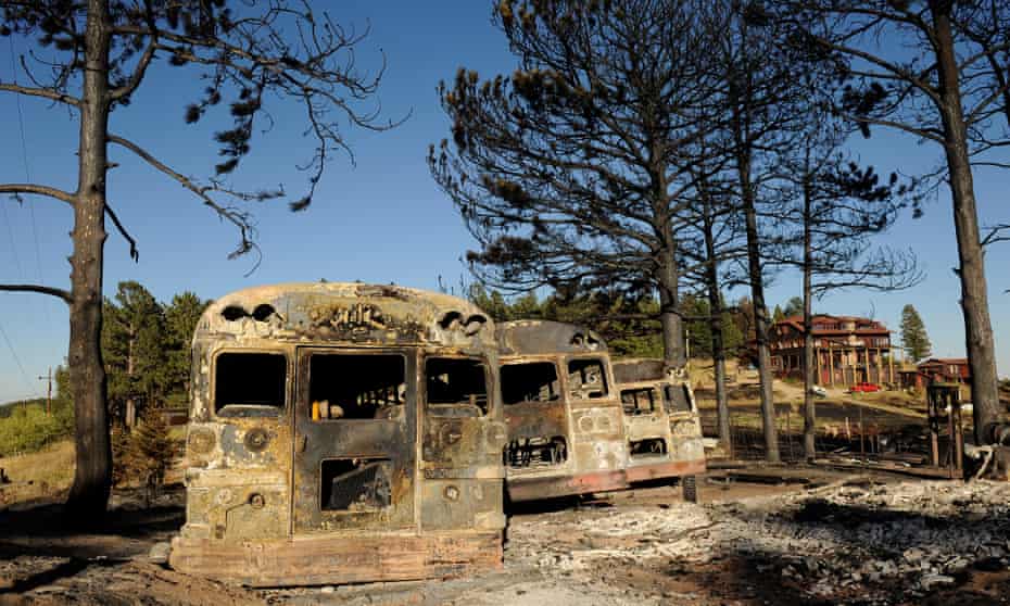 Burned buses at the Colorado Mountain Ranch in the historic town of Gold Hill in the Fourmile Canyon fire area in Boulder, Colorado, attest to the effects of a devastating wildfire,