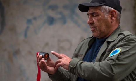 A man holds a unit of a cluster bomb in Stepanakert, the capital of Nagorno-Karabakh.