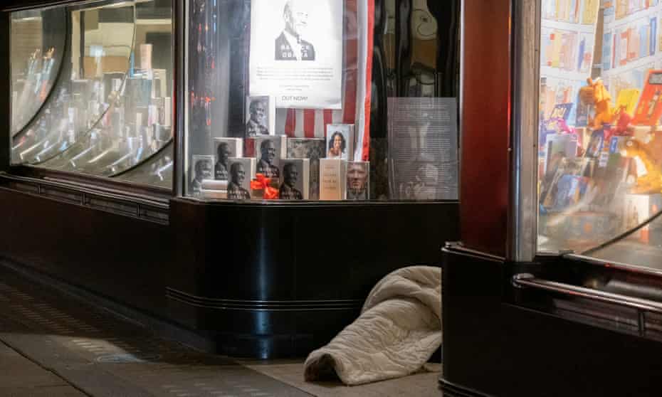 A homeless person lies in a doorway in Piccadilly, London