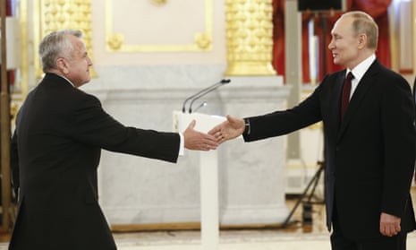 John Sullivan (left) shakes hands with the Russian president, Vladimir Putin, in Moscow in January 2020