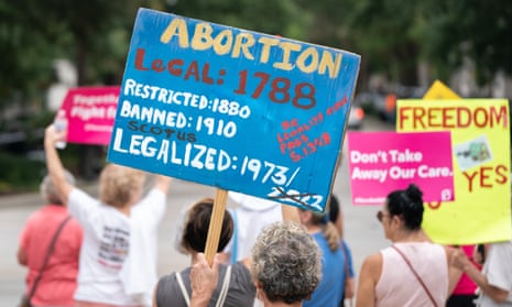 Protesters hold signs against banning abortion in front of the South Carolina statehouse in August 2022. 