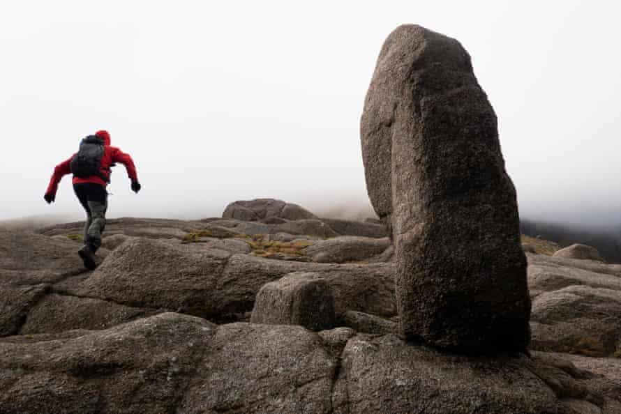 Graeme Marshall practises his bouldering skills connected  the mode   to Leabaidh an Daimh Bhuidhe astatine  the Sneck by Ben Avon successful  Cairngorms