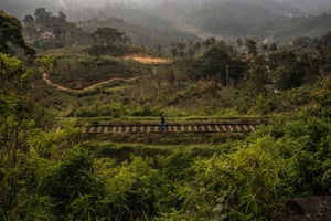 Two people walk on the railway that connects Colombo with the Badulla district