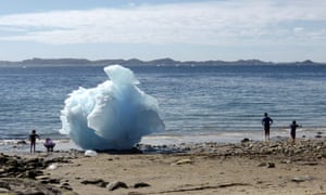 Children play amid icebergs on the beach in Nuuk, Greenland, 5 June  2016