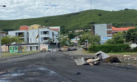 Burnt-out cars and debris litter the streets of New Caledonia’s capital, Nouméa