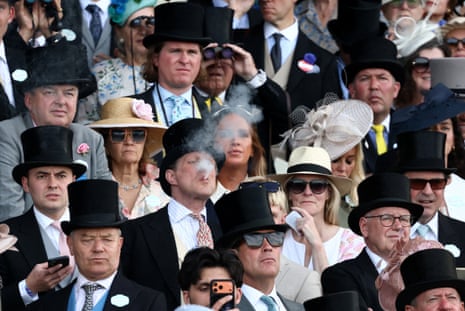General view of a racegoer smoking in the stands during the Coventry Stakes.