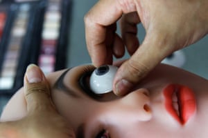 An eye is fitted to a doll