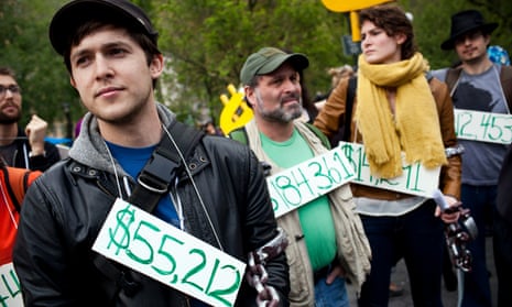 Demonstrators wear signs around their necks representing their student debt during a protest in New York on 25 April 2012. 