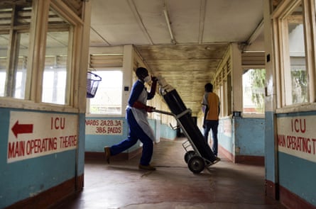 A health worker carrying oxygen at Queen Elizabeth Central Hospital in Blantyre, Malawi