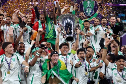 Roberto Firmino of Al-Ahli lifts the AFC Champions League trophy.